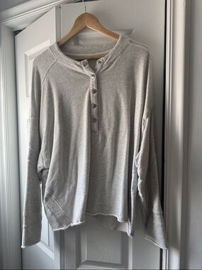 Free People light gray henley with pink logo tag